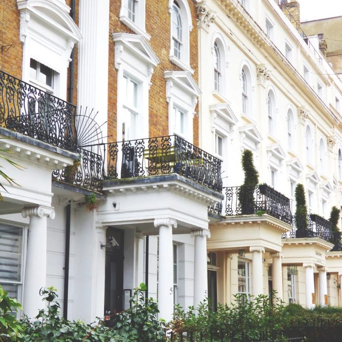 row of tall townhomes with balconies and columns