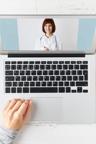 aerial view of person working on laptop with notes