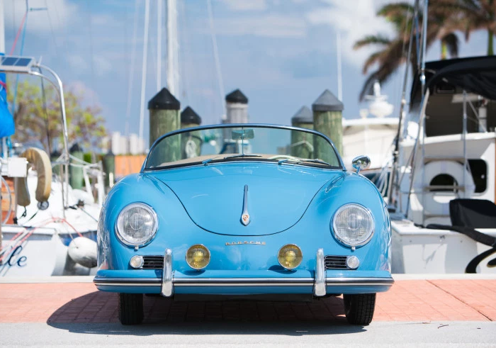 vintage car at a marina on a sunny day